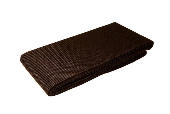 Folded dark brown textured fabric belt on a white background